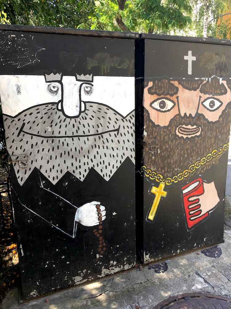 Street art of two cartoon religious priests