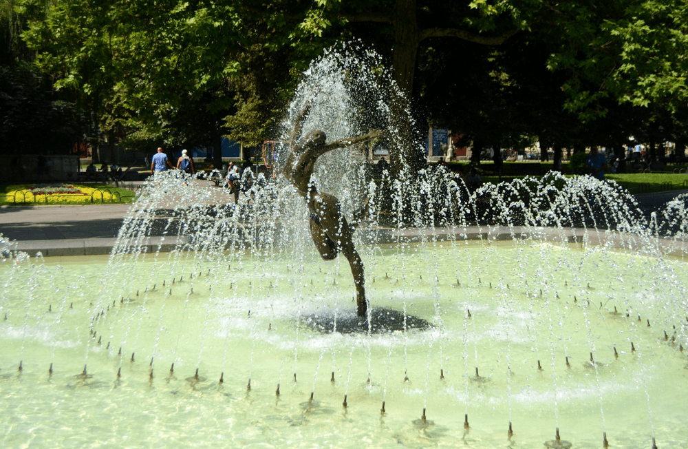 A fountain with a dancing woman sculpture